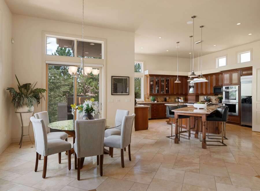 This spacious open-concept kitchen and dining area features a large island with seating, ample cabinet space, and modern appliances.