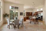This spacious open-concept kitchen and dining area features a large island with seating, ample cabinet space, and modern appliances.