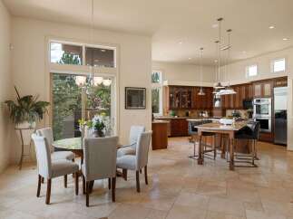 This spacious open-concept kitchen and dining area features a large island with seating, ample cabinet space, and modern appliances.