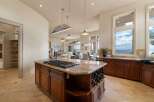 Experience luxury in this stunning kitchen, featuring a spacious island with a gas range and wine storage.