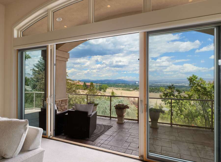 Experience breathtaking panoramic views from this stunning property, featuring expansive sliding glass doors that seamlessly blend indoor and outdoor living.