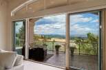 Experience breathtaking panoramic views from this stunning property, featuring expansive sliding glass doors that seamlessly blend indoor and outdoor living.
