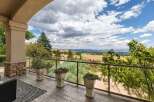 Enjoy breathtaking panoramic views from this stunning property's expansive balcony, perfect for entertaining or quiet relaxation.