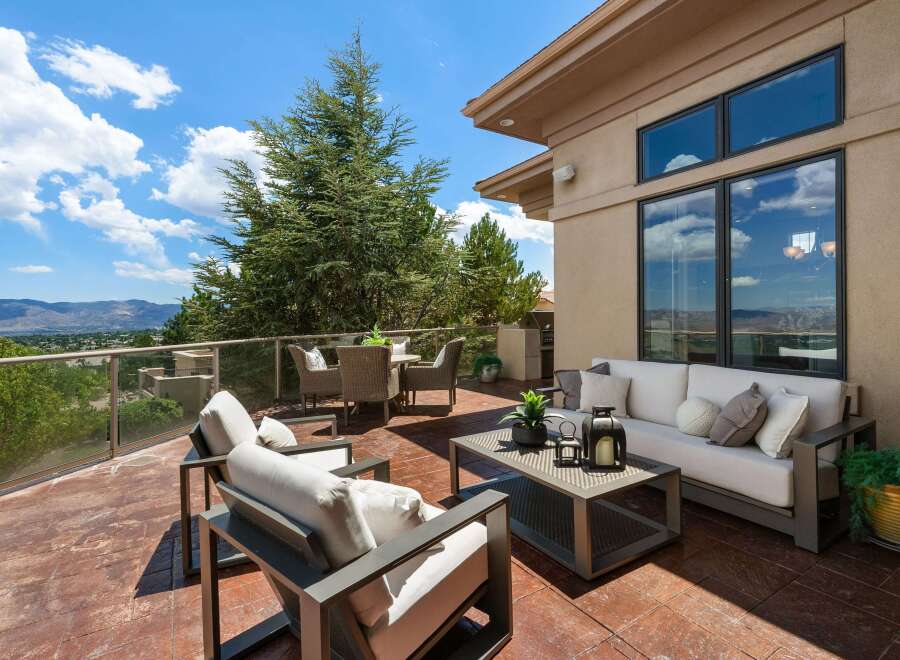 Enjoy breathtaking panoramic views from this expansive outdoor living space, perfect for entertaining or quiet relaxation.