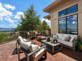 Enjoy breathtaking panoramic views from this expansive outdoor living space, perfect for entertaining or quiet relaxation.