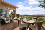 Enjoy breathtaking panoramic views from this expansive patio, perfect for entertaining or quiet relaxation.