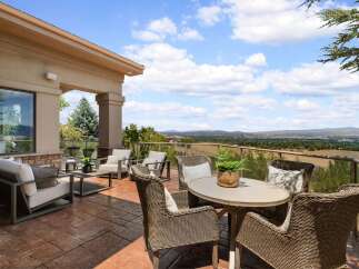 Enjoy breathtaking panoramic views from this expansive patio, perfect for entertaining or quiet relaxation.