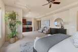 Experience luxury in this spacious master suite, featuring a private wet bar with a mini-fridge and microwave, perfect for in-room refreshments.