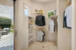 Discover this charming walk-in closet, perfect for organizing your wardrobe.