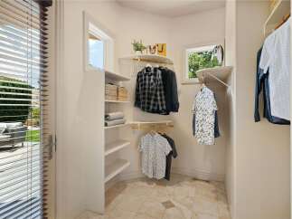 Discover this charming walk-in closet, perfect for organizing your wardrobe.