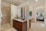 Experience luxury in this master bathroom featuring a spacious marble shower and a double vanity with ample storage.