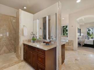 Experience luxury in this master bathroom featuring a spacious marble shower and a double vanity with ample storage.