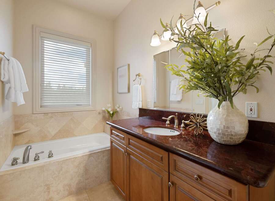 Indulge in relaxation in this elegant bathroom, featuring a spacious soaking tub perfect for unwinding after a long day.