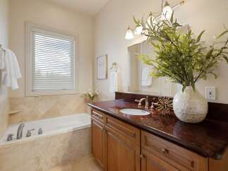 Indulge in relaxation in this elegant bathroom, featuring a spacious soaking tub perfect for unwinding after a long day.