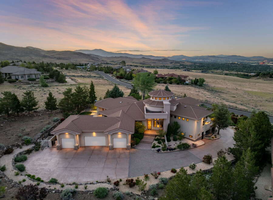 Experience luxury living in this stunning custom-built estate, nestled on a hillside with panoramic views of the valley and distant mountains.