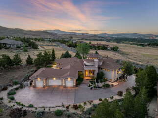 Experience luxury living in this stunning custom-built estate, nestled on a hillside with panoramic views of the valley and distant mountains.