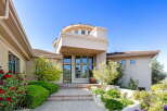 Welcome to this stunning home featuring a grand entrance with a multi-level facade and a prominent circular turret.