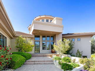 Welcome to this stunning home featuring a grand entrance with a multi-level facade and a prominent circular turret.