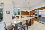 This spacious kitchen boasts custom cherry wood cabinetry and a large granite island, perfect for entertaining.