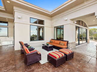 Enjoy outdoor living in this spacious patio area, perfect for entertaining guests or relaxing with family.