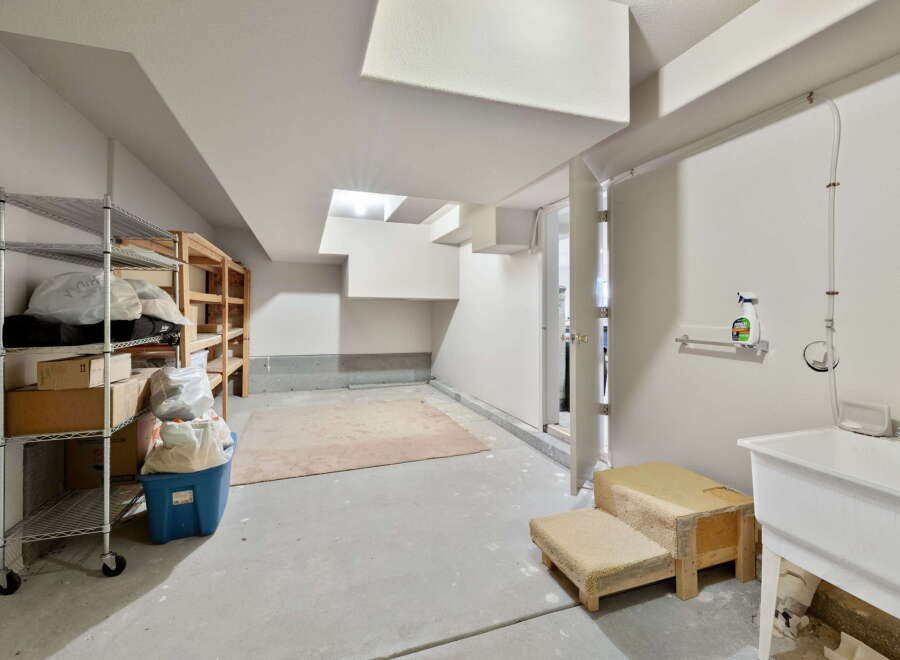 This versatile space offers ample storage with metal and wooden shelving units, perfect for organizing your belongings.