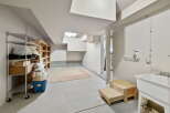 This versatile space offers ample storage with metal and wooden shelving units, perfect for organizing your belongings.