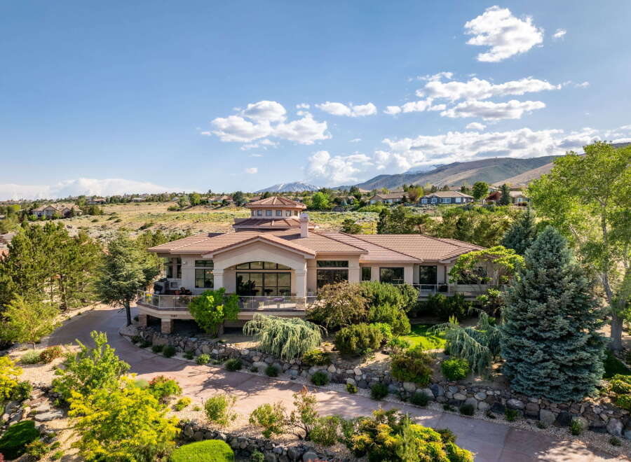 Experience luxury living in this stunning estate, featuring a grand circular turret and expansive windows that capture breathtaking mountain views.