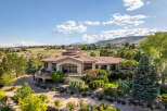 Experience luxury living in this stunning estate, featuring a grand circular turret and expansive windows that capture breathtaking mountain views.