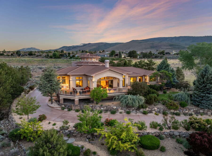 Experience luxury living in this stunning estate, featuring a grand circular rotunda and expansive wrap-around deck perfect for entertaining.