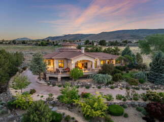 Experience luxury living in this stunning estate, featuring a grand circular rotunda and expansive wrap-around deck perfect for entertaining.