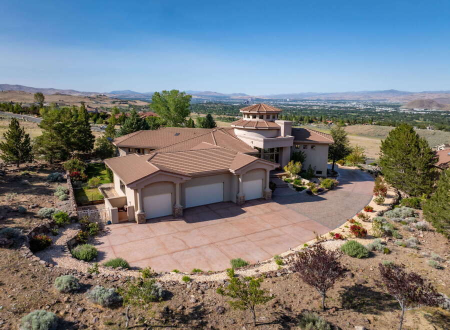 Experience luxury living in this stunning hillside estate, boasting panoramic views of the valley and distant mountains.
