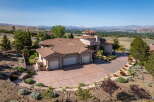Experience luxury living in this stunning hillside estate, boasting panoramic views of the valley and distant mountains.