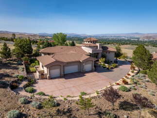 Experience luxury living in this stunning hillside estate, boasting panoramic views of the valley and distant mountains.