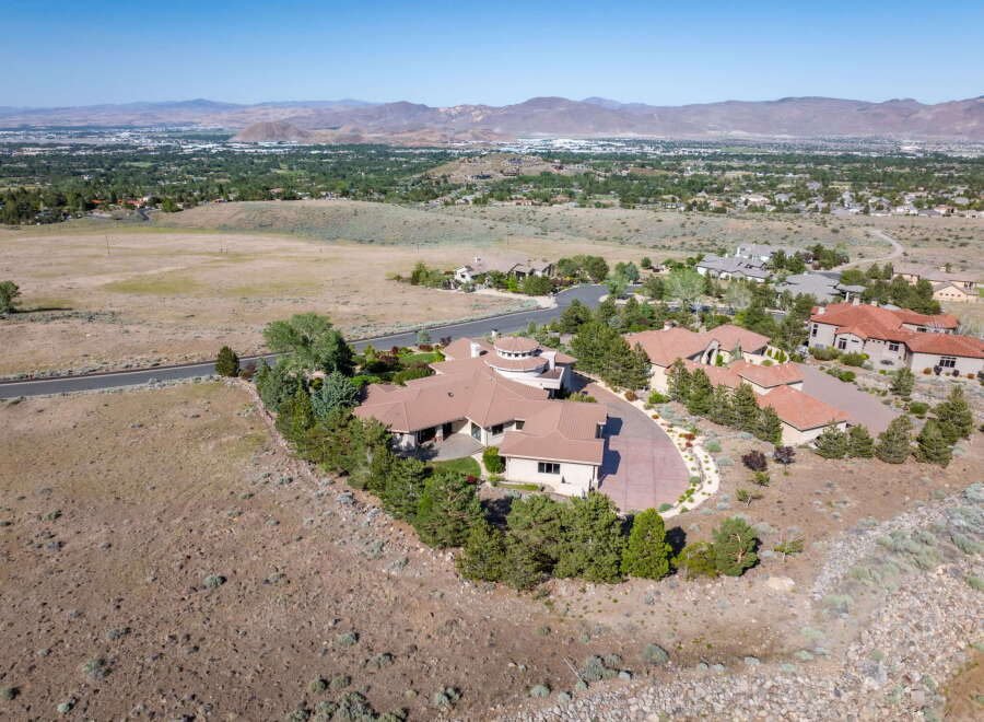 Experience luxury living in this expansive estate, featuring a sprawling multi-winged residence with a distinctive circular turret.