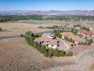 Experience luxury living in this expansive estate, featuring a sprawling multi-winged residence with a distinctive circular turret.