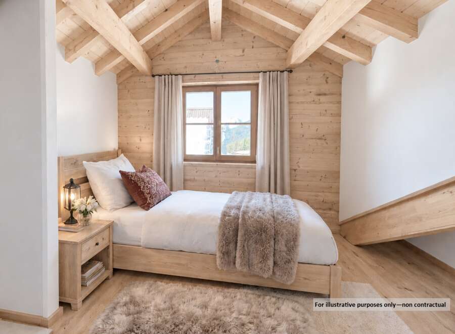 Experience cozy mountain living in this charming bedroom featuring a comfortable bed adorned with plush bedding and a decorative accent pillow.