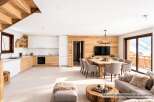 Experience modern alpine living in this stunning open-concept space, featuring a gourmet kitchen with sleek cabinetry and a spacious dining area perfect for gatherings.