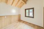 Experience the charm of this beautifully appointed room, featuring a vaulted wooden beam ceiling that adds warmth and character.