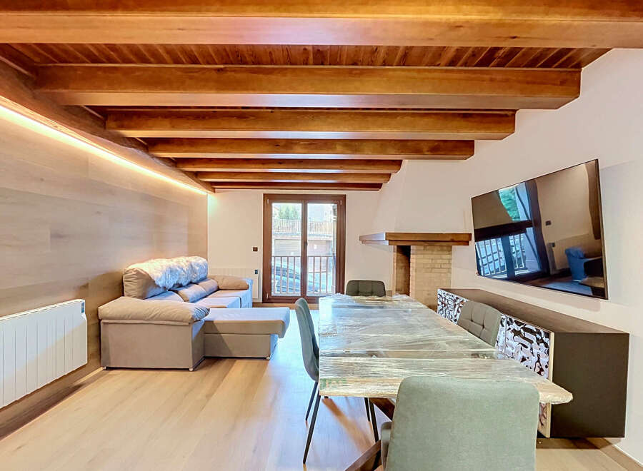 Experience modern living in this beautifully appointed space featuring exposed wooden beams and ambient lighting.