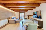 Experience modern living in this beautifully appointed space featuring exposed wooden beams and ambient lighting.