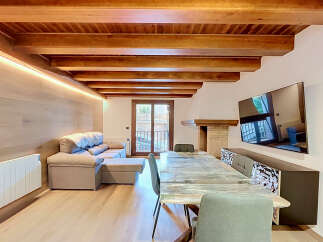 Experience modern living in this beautifully appointed space featuring exposed wooden beams and ambient lighting.