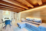 Experience modern living in this beautifully designed space featuring exposed wooden beams and warm, ambient lighting.