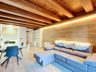 Experience modern living in this beautifully designed space featuring exposed wooden beams and warm, ambient lighting.