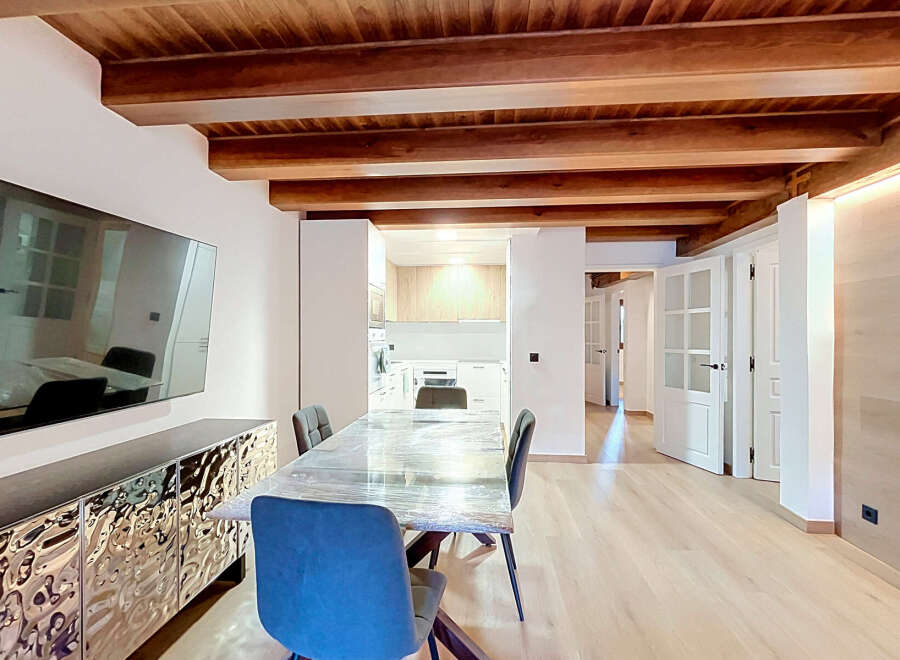 Experience modern living in this beautifully renovated space featuring exposed wooden beams and a sleek, contemporary design.
