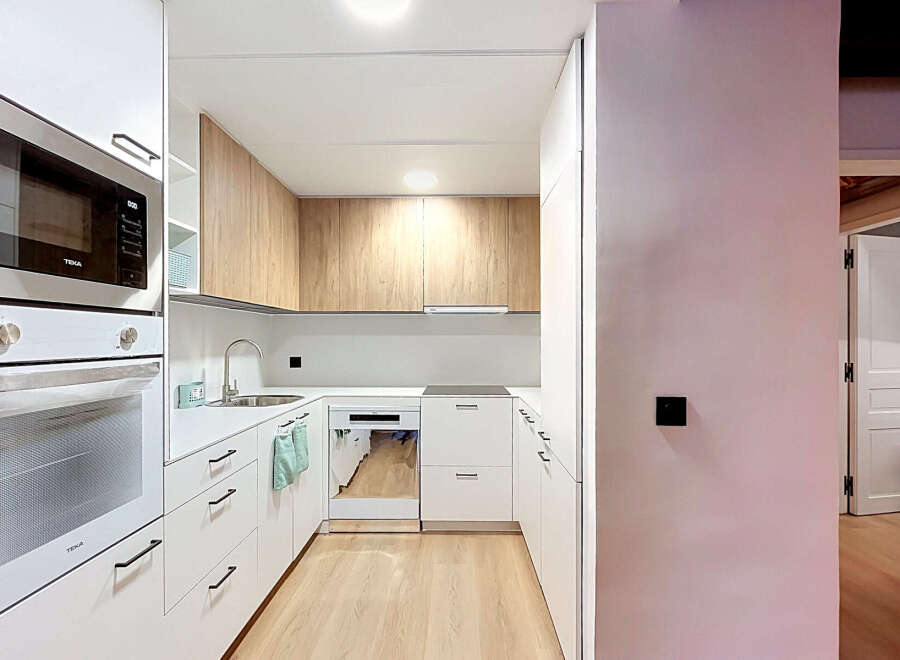 Discover this modern and functional kitchen, featuring sleek white cabinetry and a complementary wood-grain upper cabinet set.