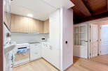 Discover this modern kitchen featuring sleek white cabinetry complemented by warm wood accents.