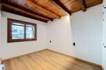 Experience rustic charm in this beautifully renovated room featuring exposed wooden beams and a warm, inviting atmosphere.