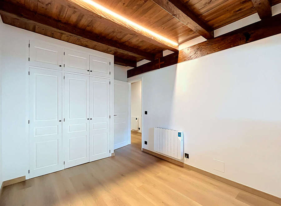 Experience modern living in this beautifully appointed room featuring a sleek white wardrobe and a contemporary radiator.