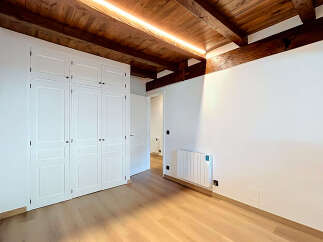 Experience modern living in this beautifully appointed room featuring a sleek white wardrobe and a contemporary radiator.