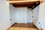 Discover this charming room featuring a built-in white wardrobe with multiple doors, perfect for ample storage.